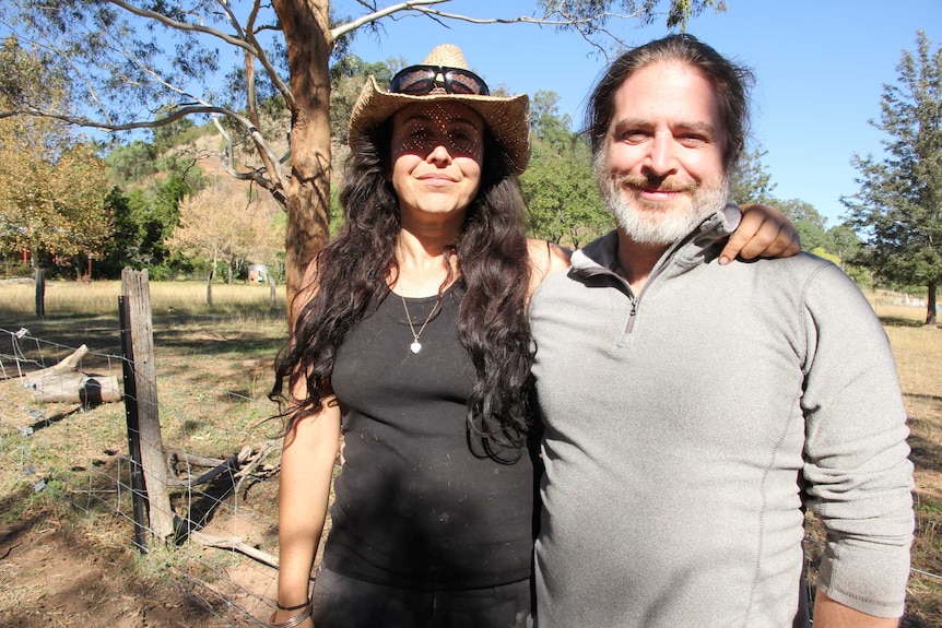 Rick and Lou Anderson standing in a paddock on their remote property in the Burragorang valley