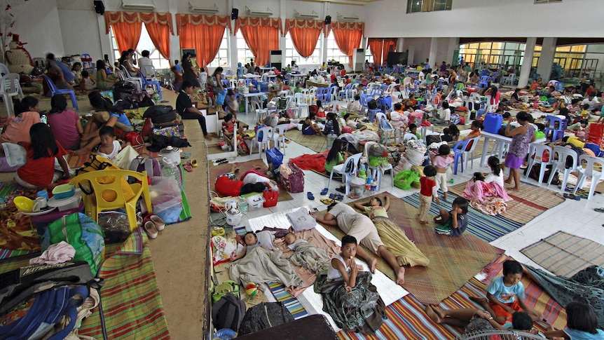 People shelter inside an evacuation centre ahead of Typhoon Hagupit