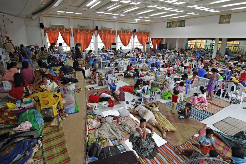 People shelter inside an evacuation centre ahead of Typhoon Hagupit