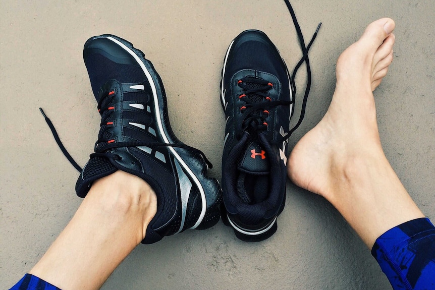 A woman puts on a pair of black sport shoes to depict how preparation can help you find more time for hobbies and goals.