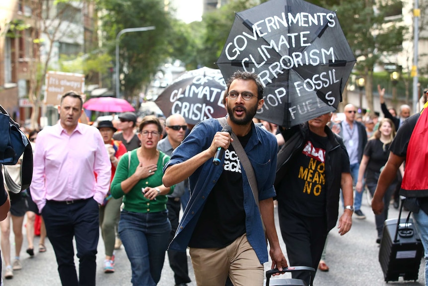 Jonathan Sri leading a climate protest
