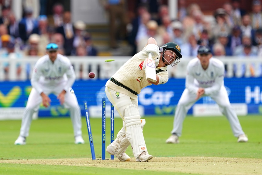 The stumps are broken and the bails are flying as David Warner is bowled