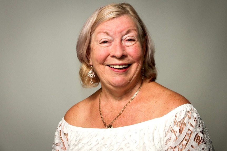 A headshot of a middle-aged woman with shoulder-length blonde hair.