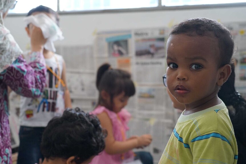 Children in the play room, covered with newspaper, in Jakarta Immigration Detention Centre.