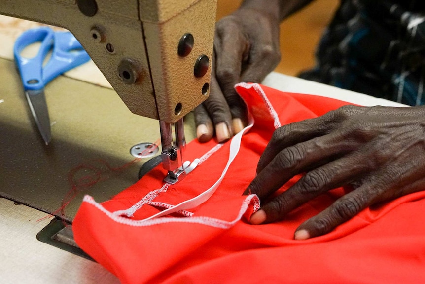 Hands work at a sewing machine