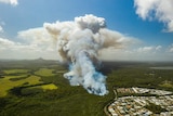 An aerial photo of smoke rising from trees at Peregian Springs