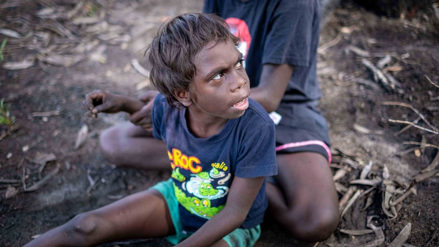 Children sit at Magela Creek in Kakadu National Park