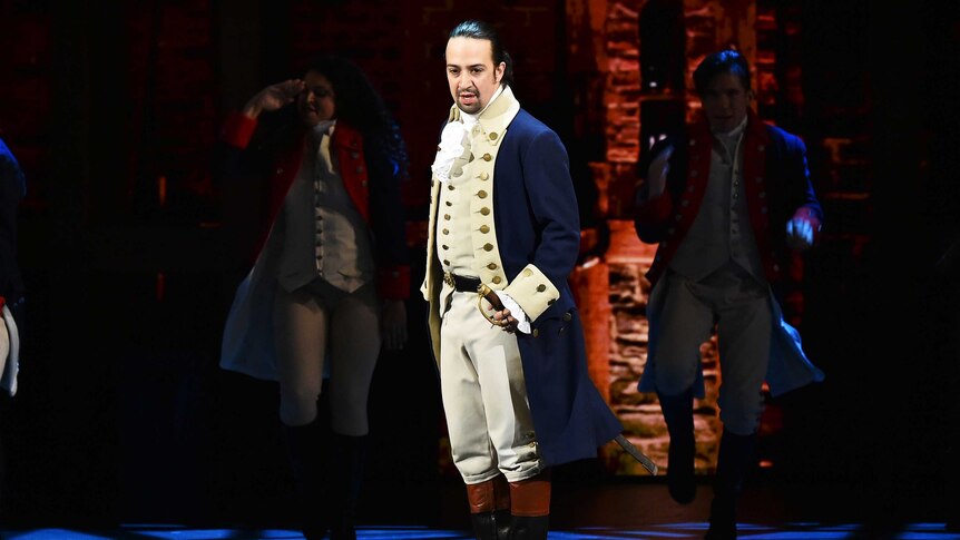 Lin-Manuel Miranda performing as Alexander Hamilton onstage.