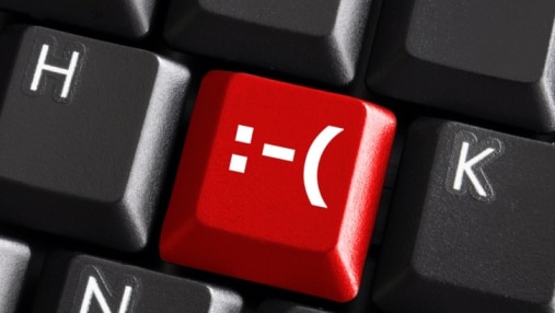 Close-up of a red negative smile key on a black keyboard (Thinkstock: Hemera)