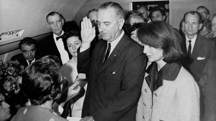 Lyndon Johnson takes the oath of office on Air Force One hours after the assassination of JFK.