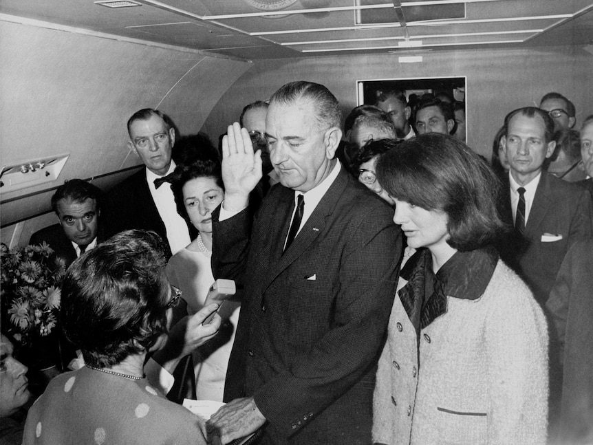 Lyndon Johnson takes the oath of office on Air Force One at Love Field Airport.