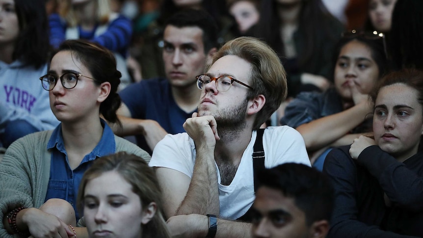 Students attend a vigil for the victims of the mass shooting in Las Vegas
