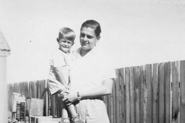 A black and white photo of a father holding his son.