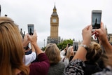 People holding smartphones record the final bongs of Big Ben.