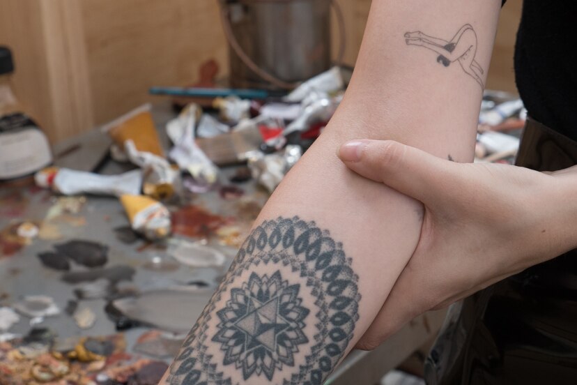 Tattoos on Ellie Kammer's arms describe her relationship with endometriosis.