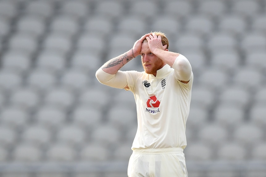 Ben Stokes holds his head in his hands against a backdrop of empty seats