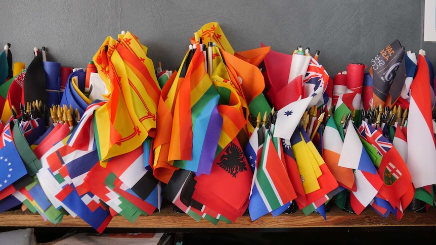 Mess of country flags on desk.