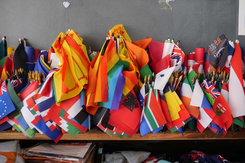 Mess of country flags on desk.