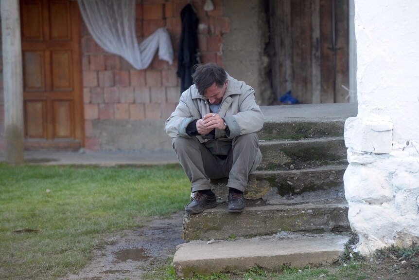 Man mourns after Serbian village massacre