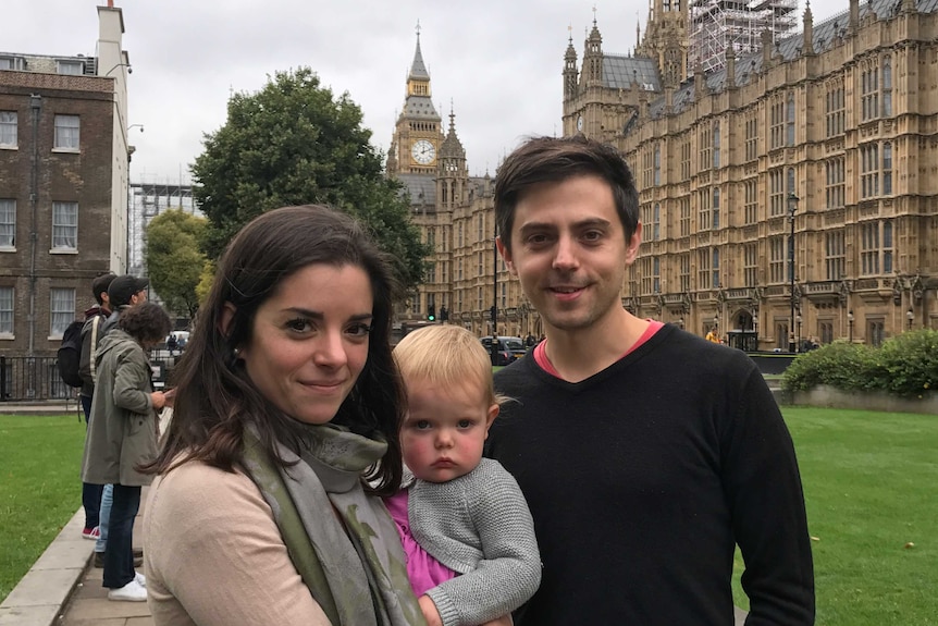 Jack and Sarah Blumenau and their daughter pose for a photo in front of Big Ben.