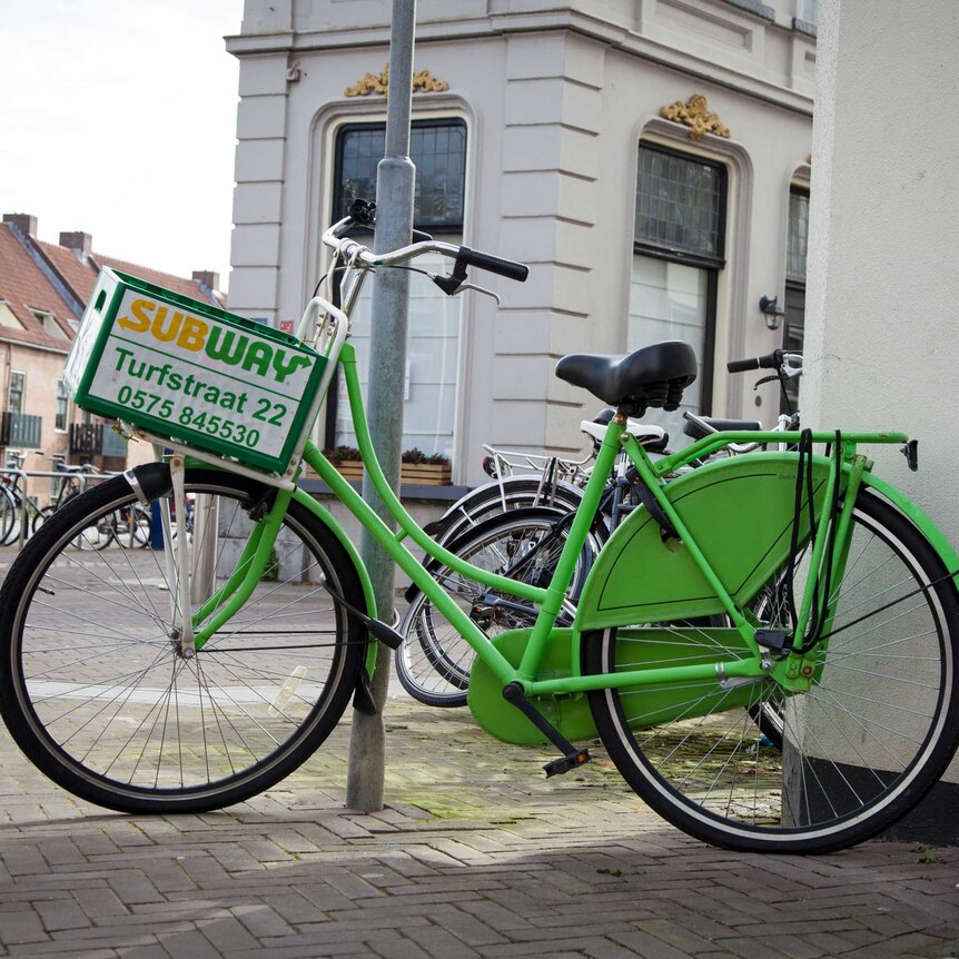 Delivery bicycle with logo of sandwich shop Subway