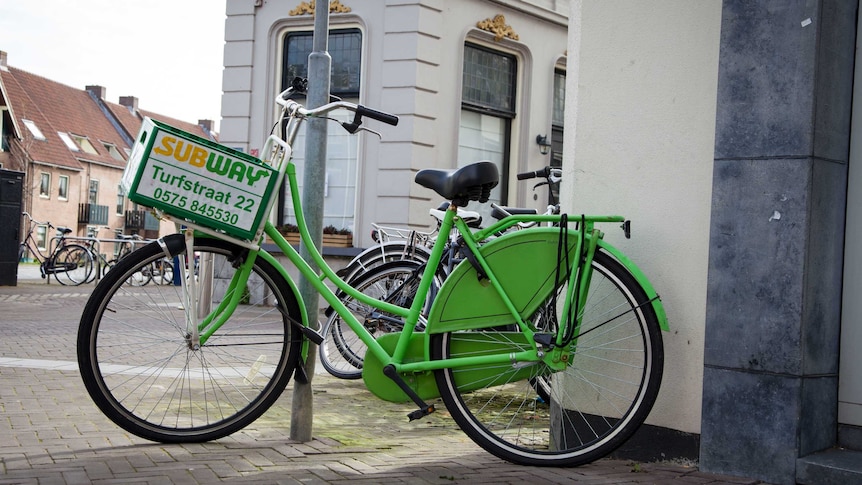 Delivery bicycle with logo of sandwich shop Subway