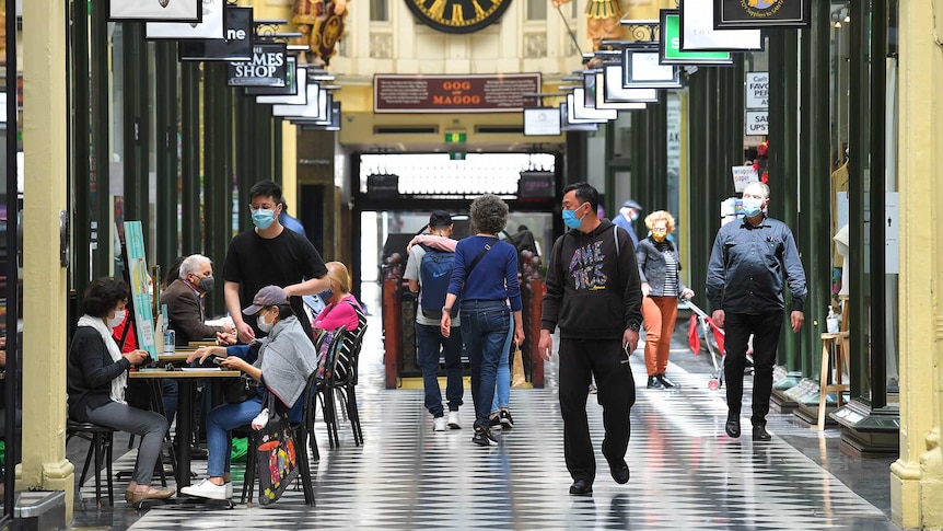 People walk through a shopping arcade