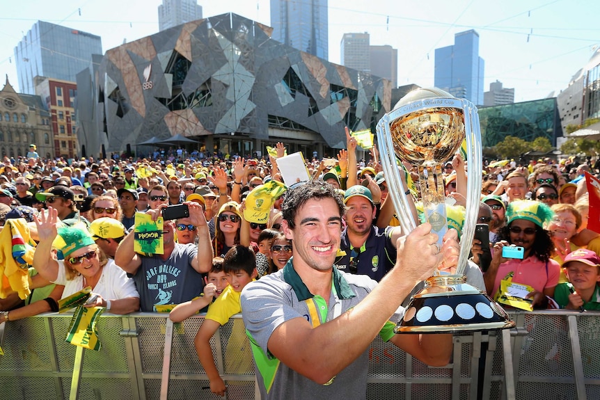 Mitchell Starc with the Cricket World Cup trophy