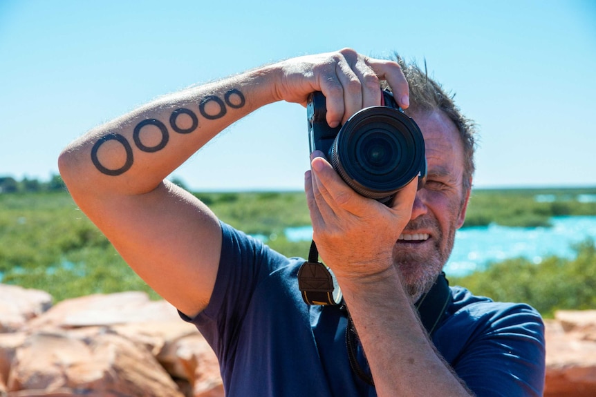 Todd Cleave taking a photo facing towards the camera