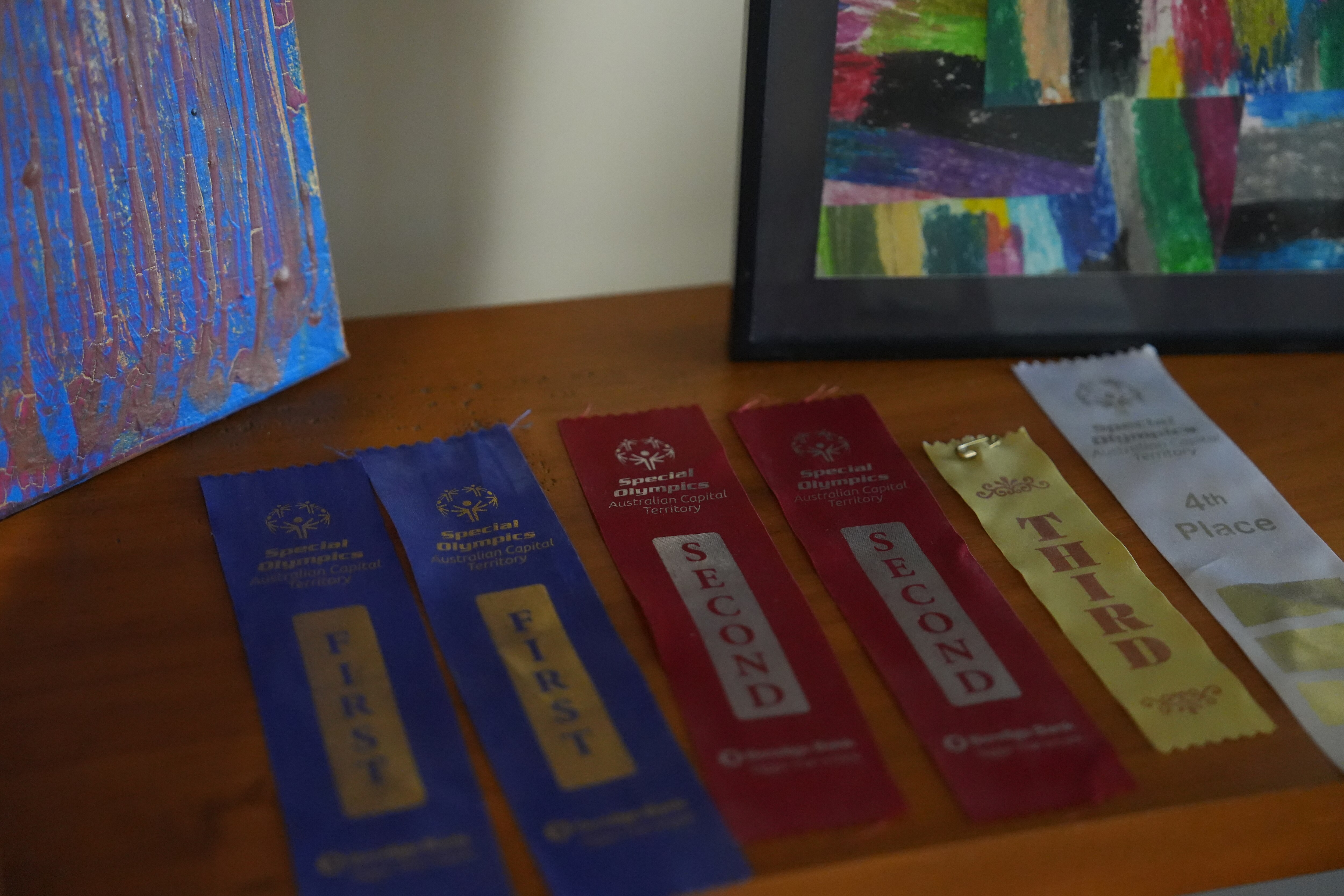 Six ribbons for placing in the Special Olympics Australian Capital Territory on a nightstand.