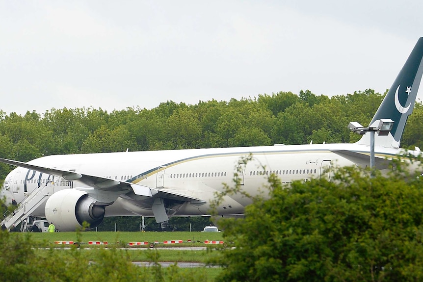 A Pakistan International Airlines Boeing 777 aircraft is parked on the tarmac at Stansted Airport.