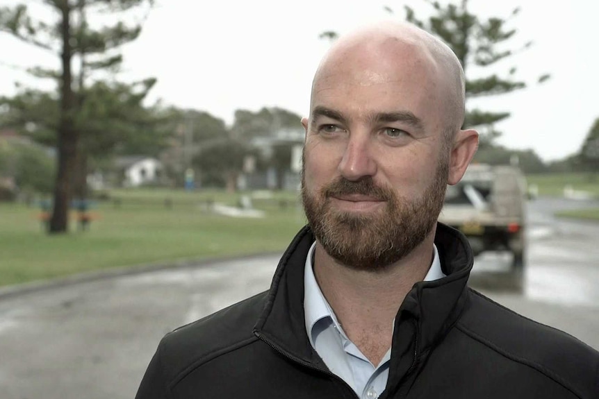 A man with a beard and shaved head.