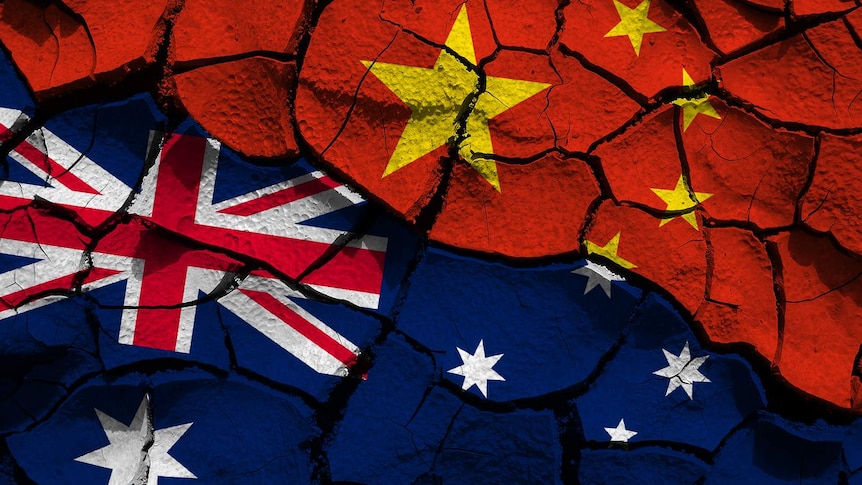 A composite of the Chinese and Australian flags on cracked ground.