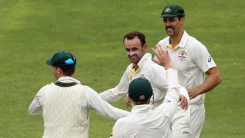 Australia's Nathan Lyon is congratulated after dismissing South Africa's Dean Elgar.