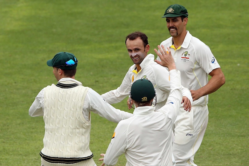 Australia's Nathan Lyon is congratulated after dismissing South Africa's Dean Elgar.