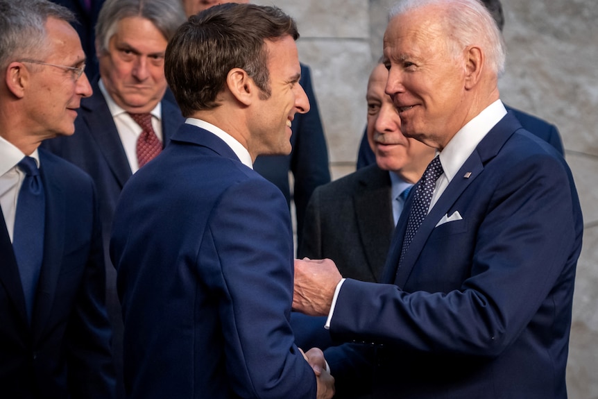 US President Joe Biden talks to France's President Emmanuel Macron
