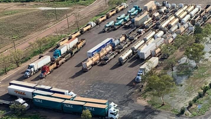 An image showing a line of trucks all stopped, packed in a row.