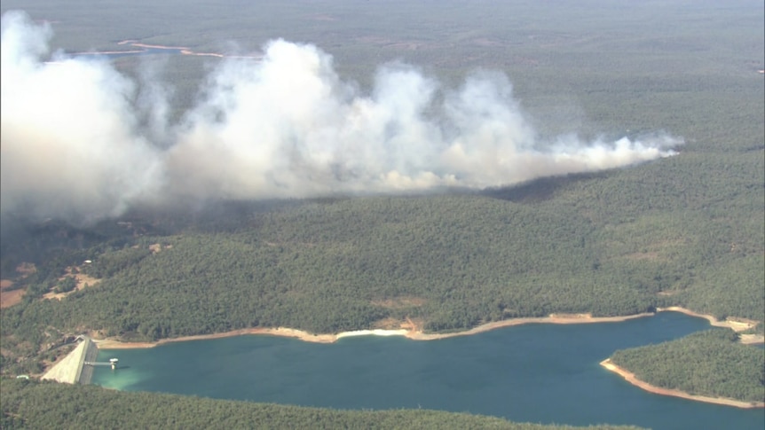 Smoke rising up from bushland seen from the air.