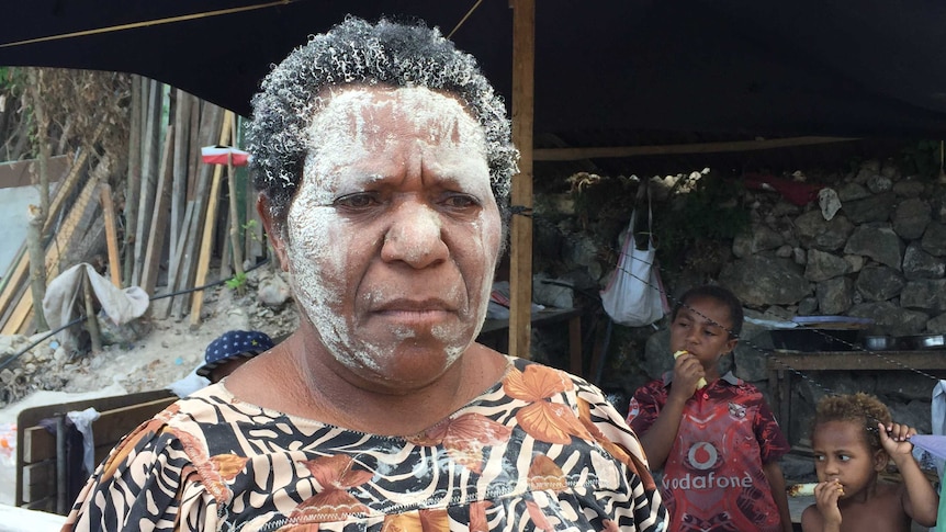 a woman wearing white facepaint