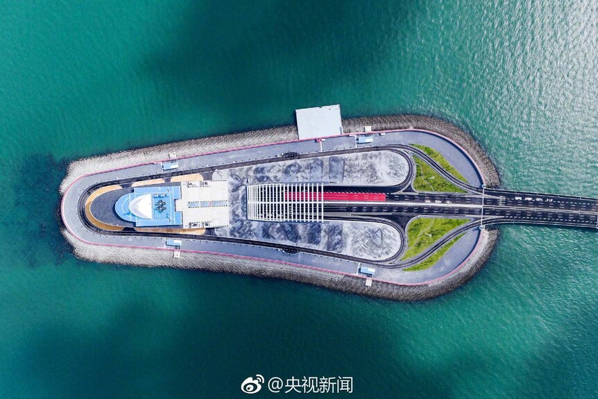 An aerial view of artificial island connected to the world's longest sea bridge.