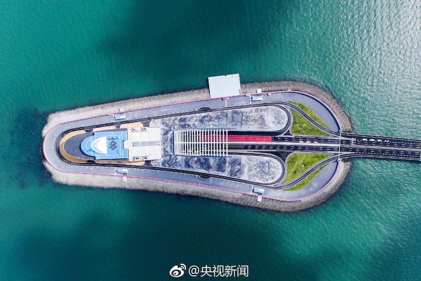 An aerial view of artificial island connected to the world's longest sea bridge.