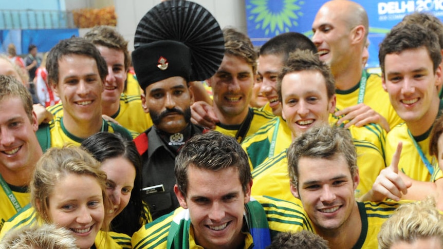 Dream team ... Geoff Huegill and a band of Aussie athletes get into the spirit after the medal ceremony.