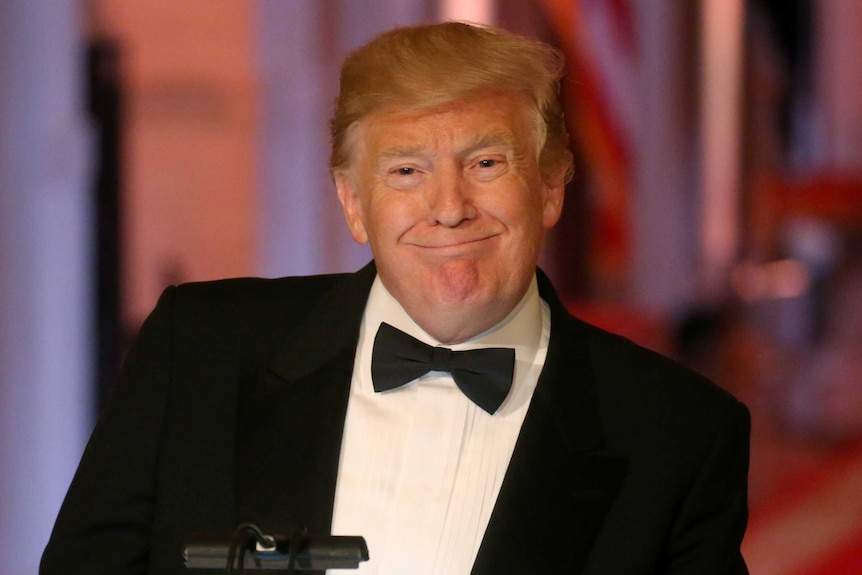 US President Donald Trump smiling while dressed in a tuxedo