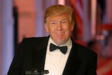US President Donald Trump smiling while dressed in a tuxedo