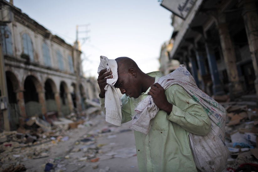 Man walks through destroyed Haiti street