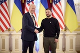 US President Joe Biden shakes hands with Ukraine President Volodymyr Zelenskyy.