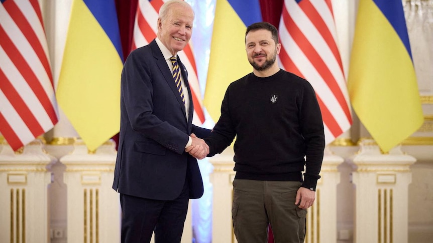 US President Joe Biden shakes hands with Ukraine President Volodymyr Zelenskyy.