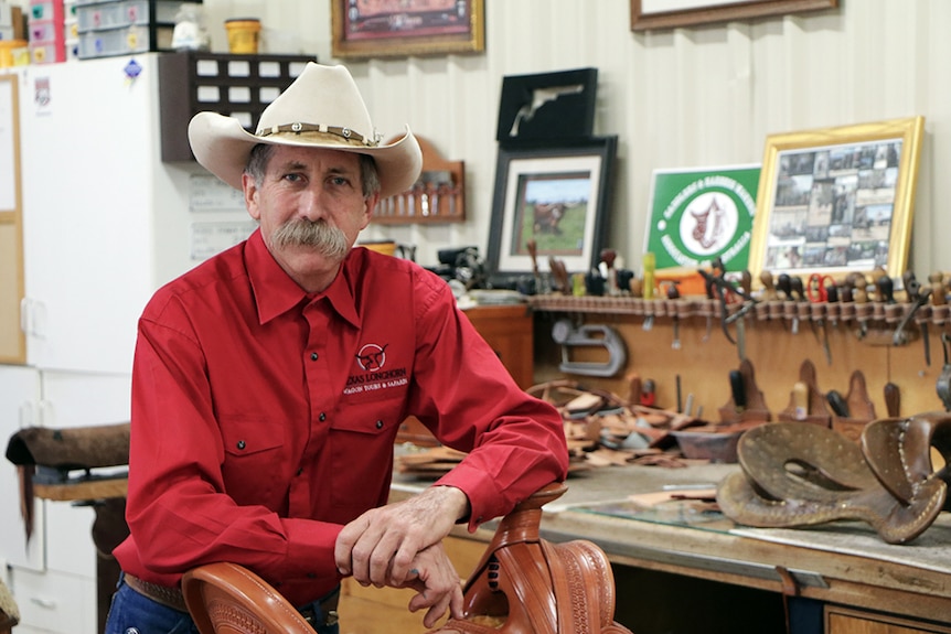 Michael Bethel leaning on saddle