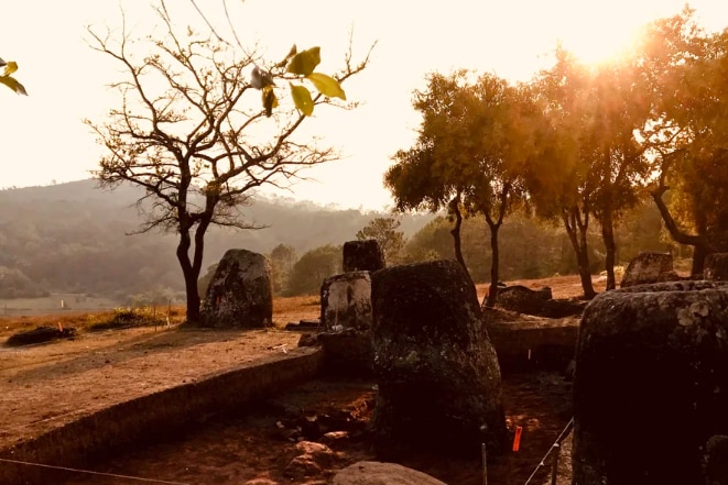 The sun setting over an archaeological site