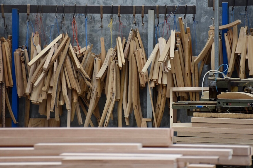 Pieces of wood hanging in a Melbourne furniture factory.